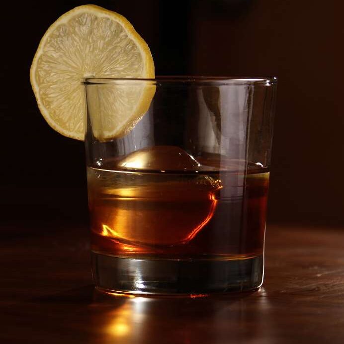 Bourbon cocktail with lemon slice garnish - Creative cocktails to make at home