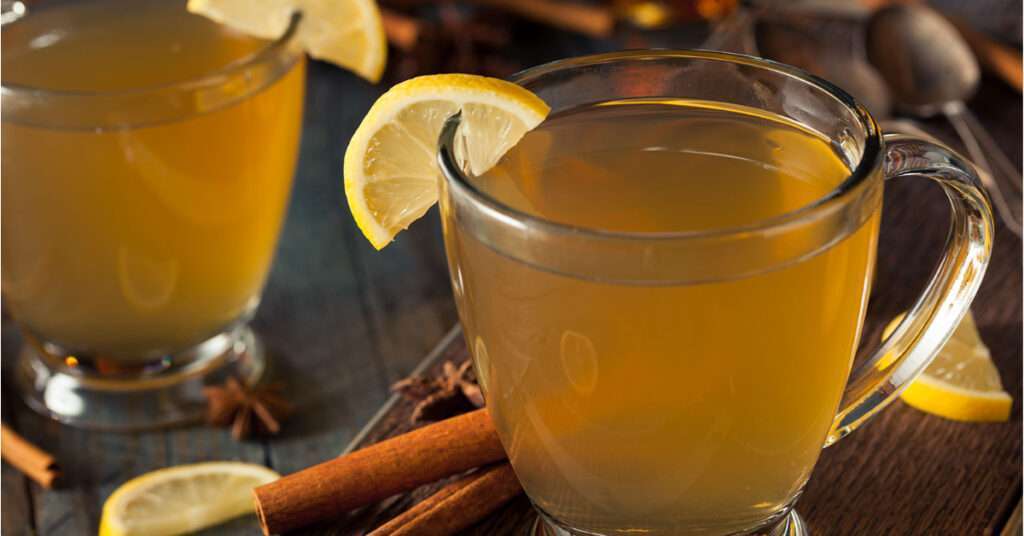 Hot Toddy with Whiskey and Tea and a lemon garnish